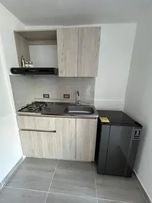 a small kitchen with a sink and a stove at Casa Vernazza in Manizales
