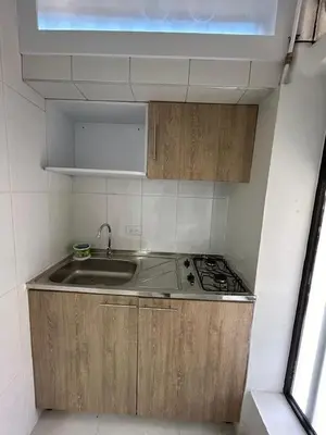 a small kitchen with a sink and a stove at Casa Vernazza in Manizales