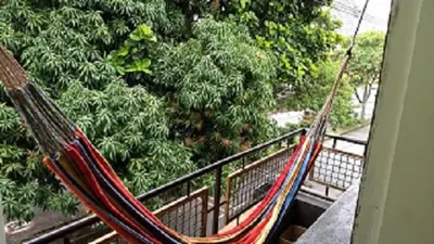 a hammock on a balcony in front of trees at usoinmobiliario in Medellín