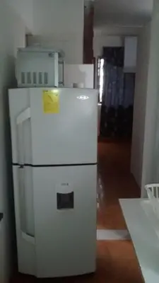 a white refrigerator with a yellow sticker on it at usoinmobiliario in Medellín