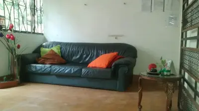 a living room with a blue couch with colorful pillows at usoinmobiliario in Medellín