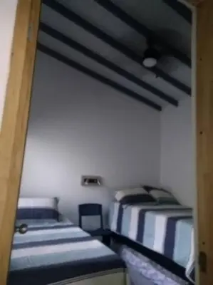 a room with two beds in a room at APARTAMENTO PRIVADO Y TRANQUILO EN MANILA. in Medellín