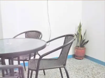 a table and chairs with a table and a potted plant at Fantástico y cómodo a 1Km de la hacienda Nápoles in Doradal