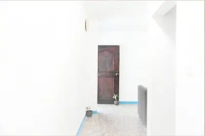 a room with a door in a white wall at Fantástico y cómodo a 1Km de la hacienda Nápoles in Doradal