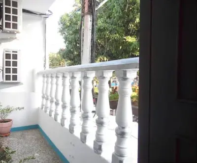 a balcony with white railings on a house at Fantástico y cómodo a 1Km de la hacienda Nápoles in Doradal