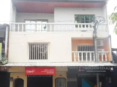 a white building with a balcony on top of it at Fantástico y cómodo a 1Km de la hacienda Nápoles in Doradal