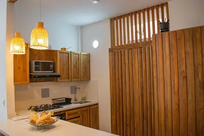 a kitchen with wooden cabinets and a counter top at Eco Apartamento Crudo in Jardin