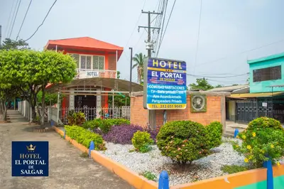 a hotel with a sign in front of a building at Hotel El Portal de Salgar in Puerto Salgar