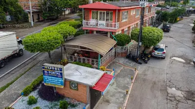 a building with a restaurant on a city street at Hotel El Portal de Salgar in Puerto Salgar