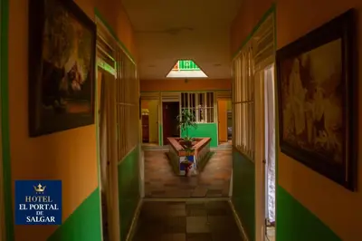 a hallway in a building with green and yellow walls at Hotel El Portal de Salgar in Puerto Salgar