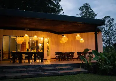 a patio with a table and chairs and lights at Monarch Campestre- Rionegro in Rionegro