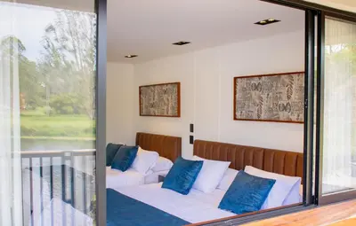 a bedroom with a bed and a glass window at Monarch Campestre- Rionegro in Rionegro