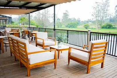 a patio with tables and chairs on a deck at Monarch Campestre- Rionegro in Rionegro