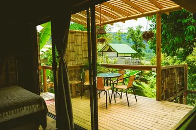 a wooden deck with a table and chairs on it at Cabaña Glamping San Carlos Antioquía Pun chinaw Ecocabañas in San Carlos
