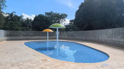 a swimming pool with an umbrella on top of it at santa fe de Antioquia pueblo apto in Santa Fe de Antioquia