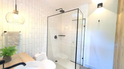 a bathroom with a shower with a toilet and a sink at santa fe de Antioquia pueblo apto in Santa Fe de Antioquia