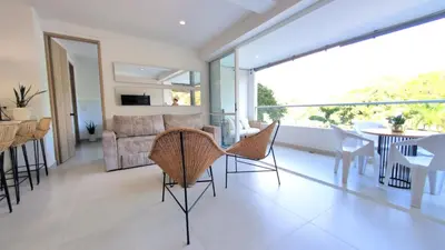 a living room with a couch and a table and chairs at santa fe de Antioquia pueblo apto in Santa Fe de Antioquia