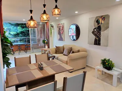 a living room with a table and a couch at Exclusivo Apto lujoso central, sereno y cómodo 302 in Medellín