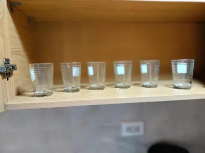 a row of glasses sitting on a shelf at Exclusivo Apto lujoso central, sereno y cómodo 302 in Medellín