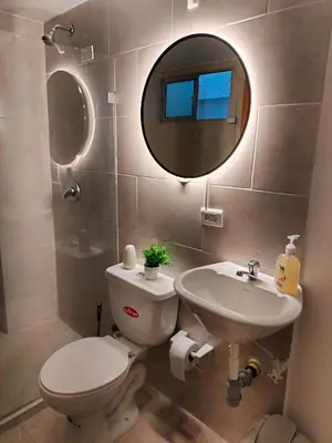 a bathroom with a toilet and a sink and a mirror at Exclusivo Apto lujoso central, sereno y cómodo 302 in Medellín