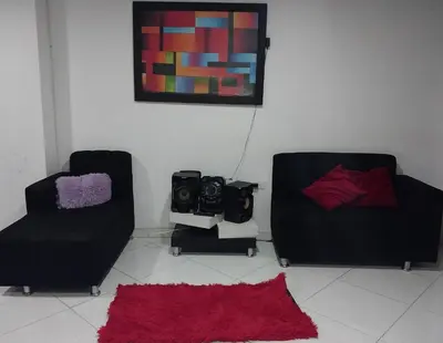 a living room with two chairs and a red rug at HABITACIÓN PRIVADA tranquila y confortable in Bello