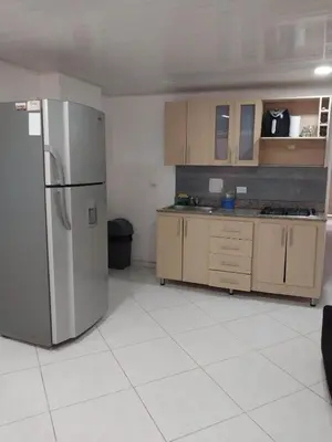 a kitchen with a stainless steel refrigerator and cabinets at HABITACIÓN PRIVADA tranquila y confortable in Bello