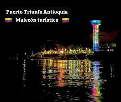 a view of a city at night with a clock tower at Apartamento Encanto in Puerto Triunfo