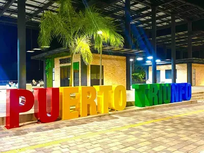 a colorful sign in front of a building at Apartamento Encanto in Puerto Triunfo