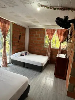 a bedroom with two beds and a brick wall at La Clarita in San Rafael