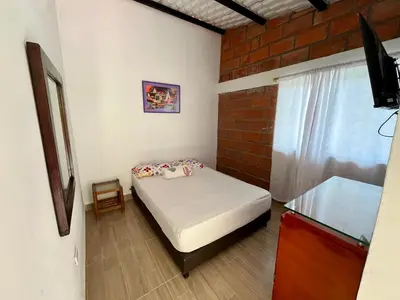 a small bedroom with a bed and a window at La Clarita in San Rafael
