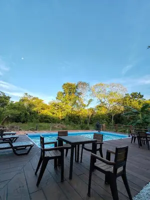 a patio with tables and chairs next to a swimming pool at Finca Campestre La Flor in Doradal