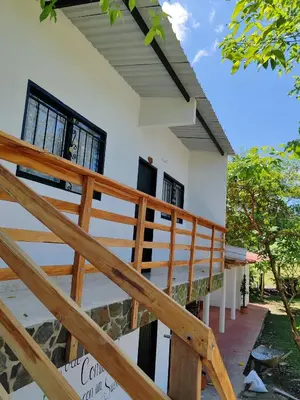 a view of the outside of a house with wooden stairs at Finca Campestre La Flor in Doradal