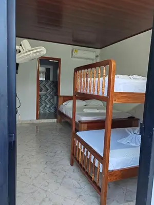 a bunk bed room with two bunk beds and a doorway at Finca Campestre La Flor in Doradal