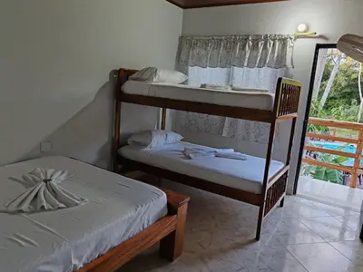 a bedroom with two bunk beds and a window at Finca Campestre La Flor in Doradal