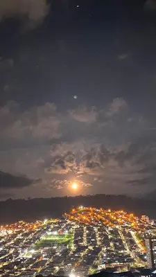 a view of a city lit up at night at Suite con hamaca y baño privado. in Manizales