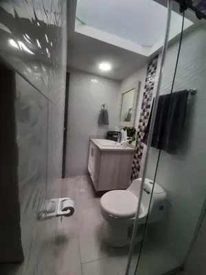 a bathroom with a toilet and a sink and a mirror at Suite con hamaca y baño privado. in Manizales