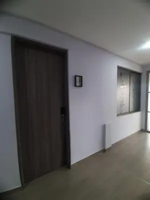 an empty room with a door and a window at Suite con hamaca y baño privado. in Manizales