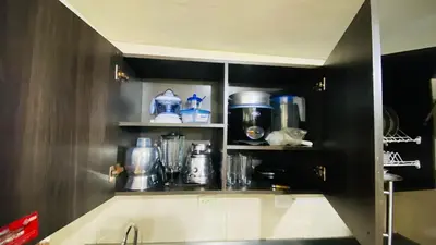 a kitchen with a cupboard filled with appliances at Casa Confortable 2 habitaciones, pateo , parqueadero in Medellín