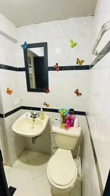 a bathroom with a toilet and a sink at Casa Confortable 2 habitaciones, pateo , parqueadero in Medellín