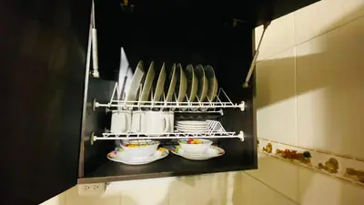 a shelf with cups and saucers in a kitchen at Casa Confortable 2 habitaciones, pateo , parqueadero in Medellín