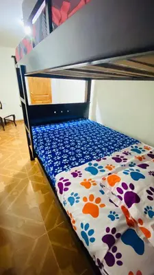 a bed with a floral comforter on a bunk bed at Casa Confortable 2 habitaciones, pateo , parqueadero in Medellín
