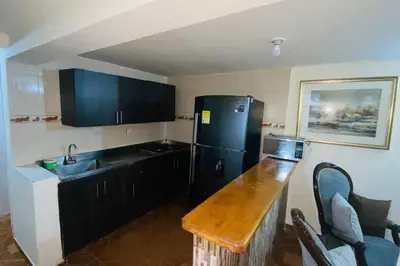 a kitchen with a black refrigerator and a sink at Casa Confortable 2 habitaciones, pateo , parqueadero in Medellín