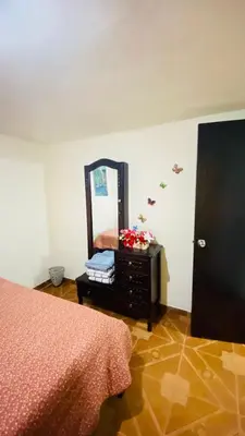 a bedroom with a bed and a dresser and a mirror at Casa Confortable 2 habitaciones, pateo , parqueadero in Medellín