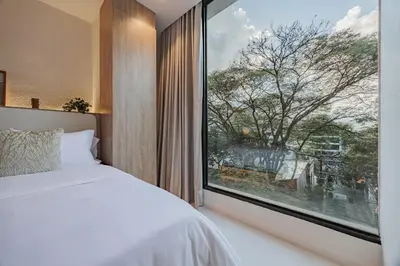 a bedroom with a large window and a bed at Primavera Building in Medellín