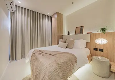 a bedroom with a large bed with a large window at Primavera Building in Medellín
