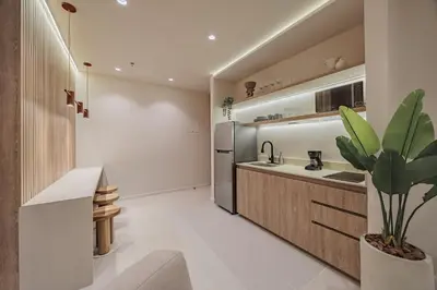 a kitchen with a sink and a refrigerator at Primavera Building in Medellín