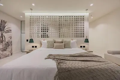 a bedroom with a large white bed and a large window at Primavera Building in Medellín