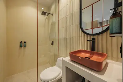 a bathroom with a sink and a toilet and a mirror at Primavera Building in Medellín