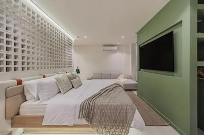 a bedroom with a large bed and a flat screen tv at Primavera Building in Medellín