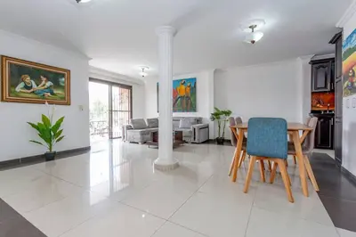 a living room with a table and a couch at ¡Apartamento HOME LAURELES excelente ubicación! in Medellín
